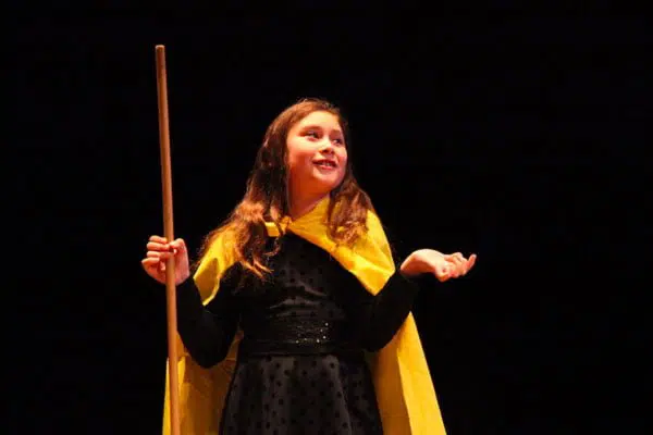 A child performing a play