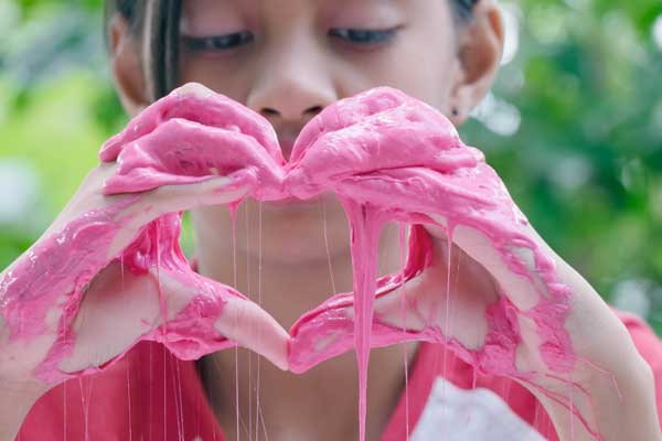 Young girl trying out home made slime